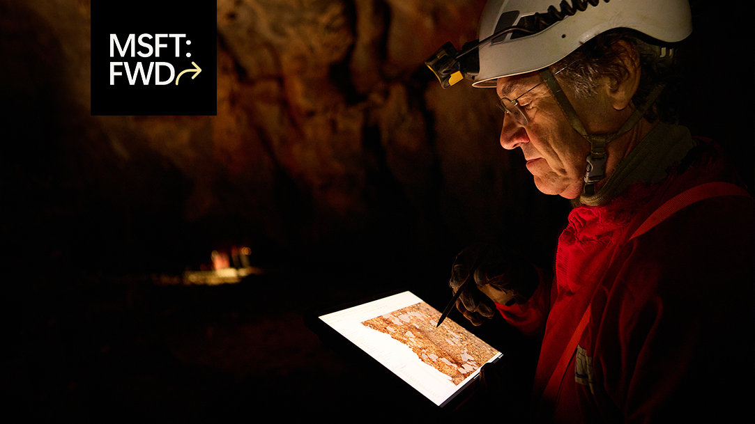 Archaeologist uses a drawing tablet with screen and pen inside a remote Spanish cave