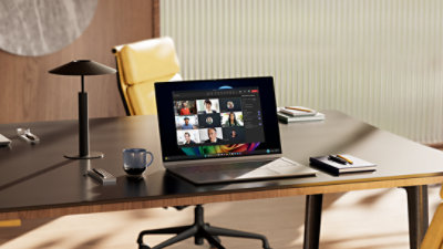 An open laptop displaying File Explorer in Windows, with tabs and AI powered recommendations in dark mode, sits on an office desk alongside notebooks and a coffee mug