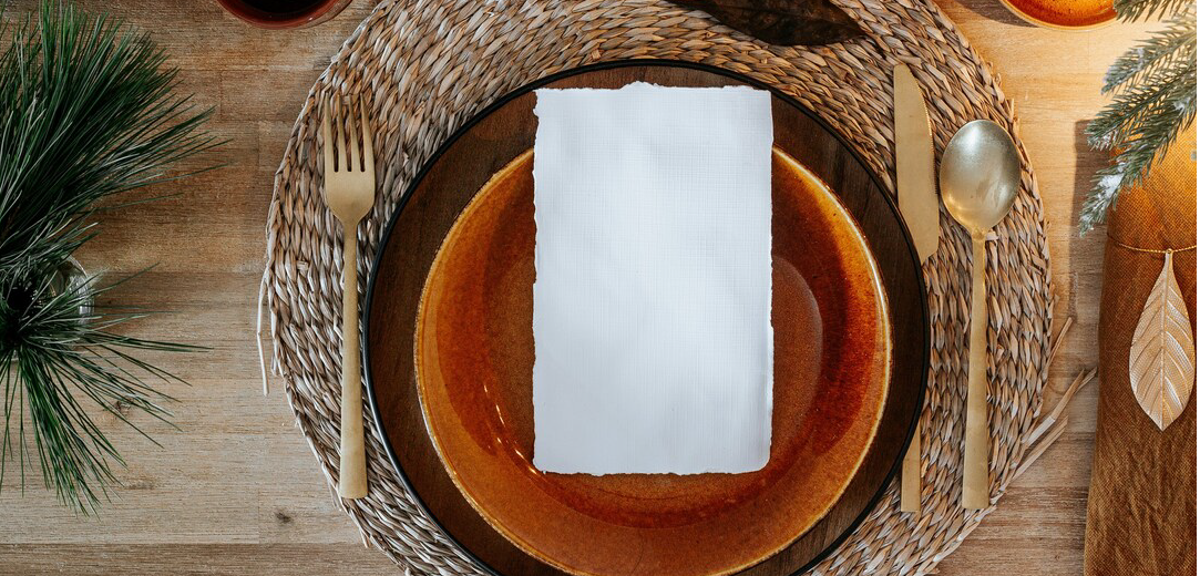 Brown and white paper on brown woven round basket photo
