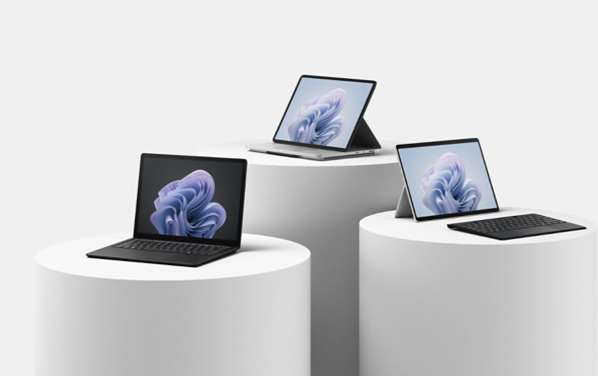 Surface Laptop Studio 2, Surface Pro 10, and Surface Laptop 6 are observed on plinths of various heights.