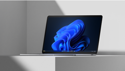 Laptop device on white platform with blue bloom