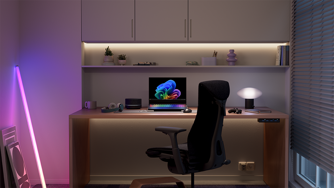 Copilot+ PC on a gaming desk with ergonomic chair, laptop, and lights
