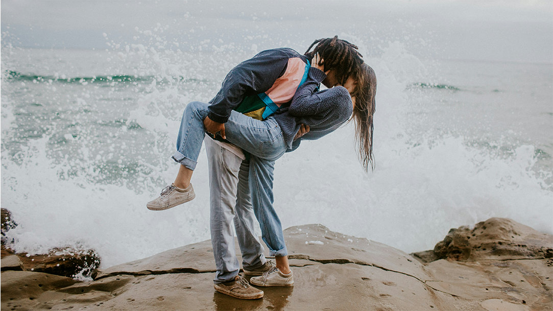 Couple kissing by the water