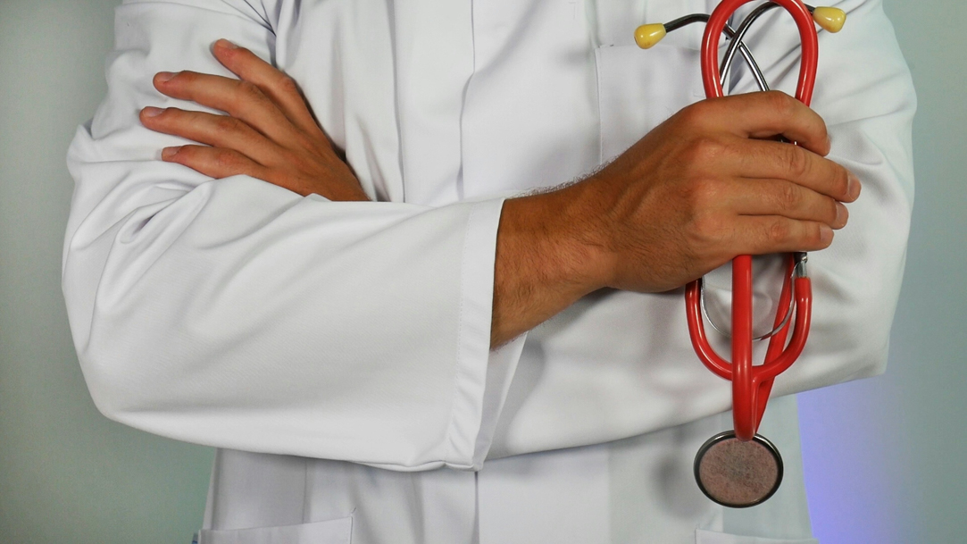 Doctor holding a red stethoscope