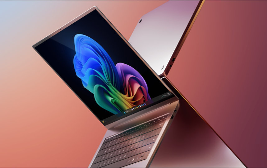 Two open laptops showing rainbow bloom design on one of the screens