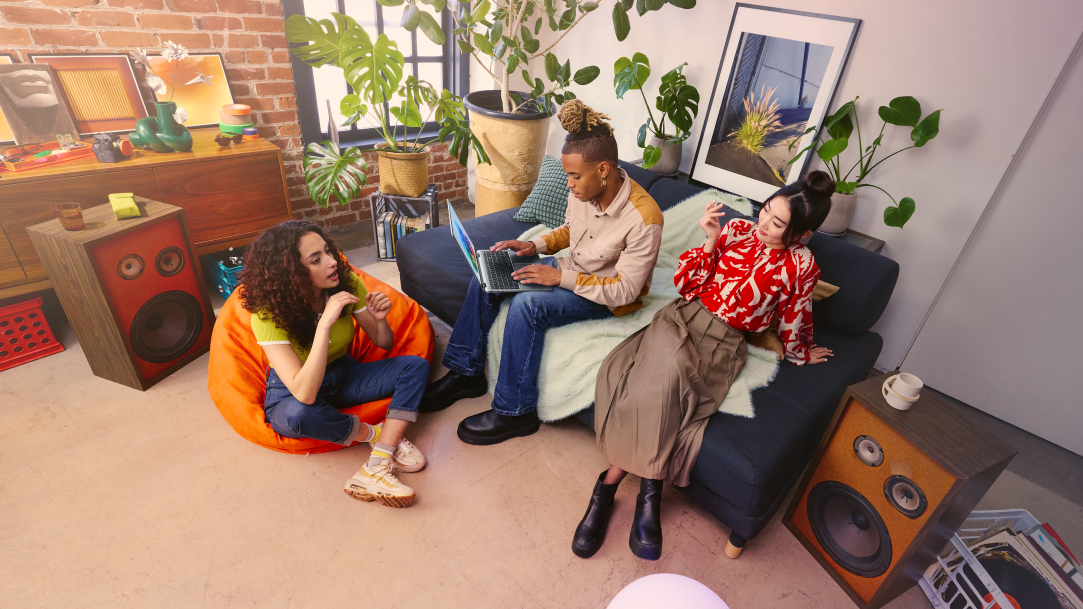 Friends in an artsy living room using an AI PC