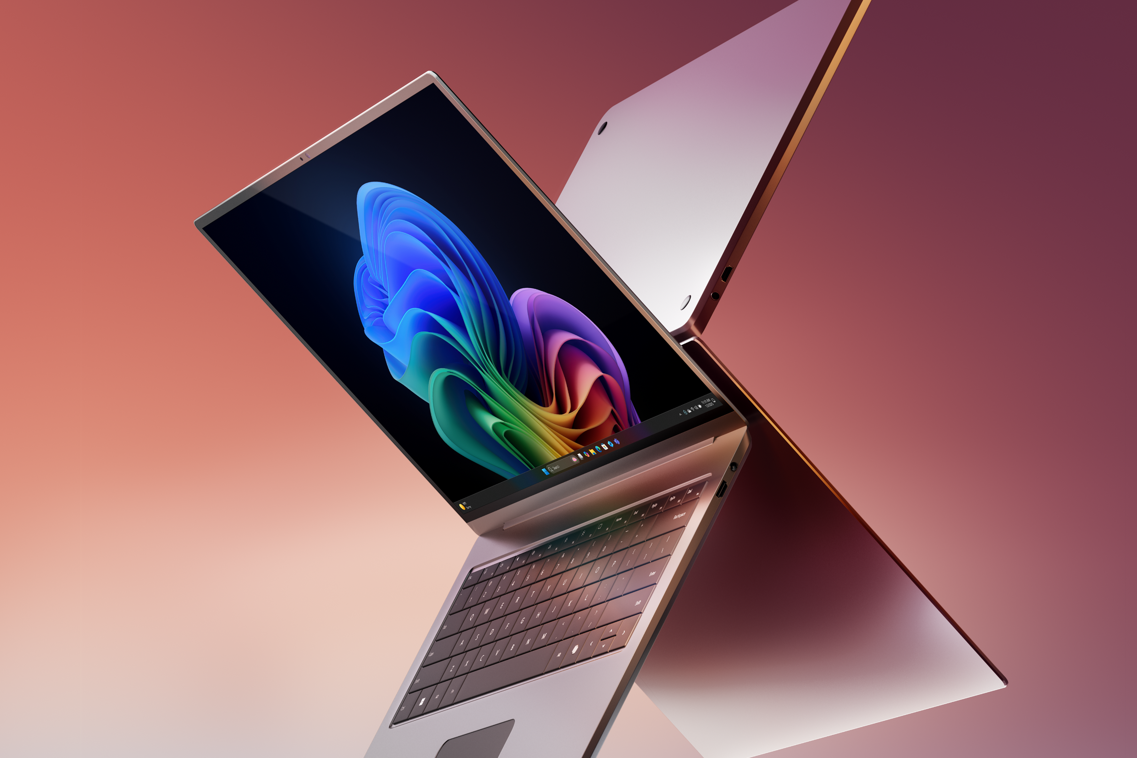 Two Windows 11 Copilot plus PCs open and dramatically back-to-back, one displaying the rainbow bloom image against a gradient violet background