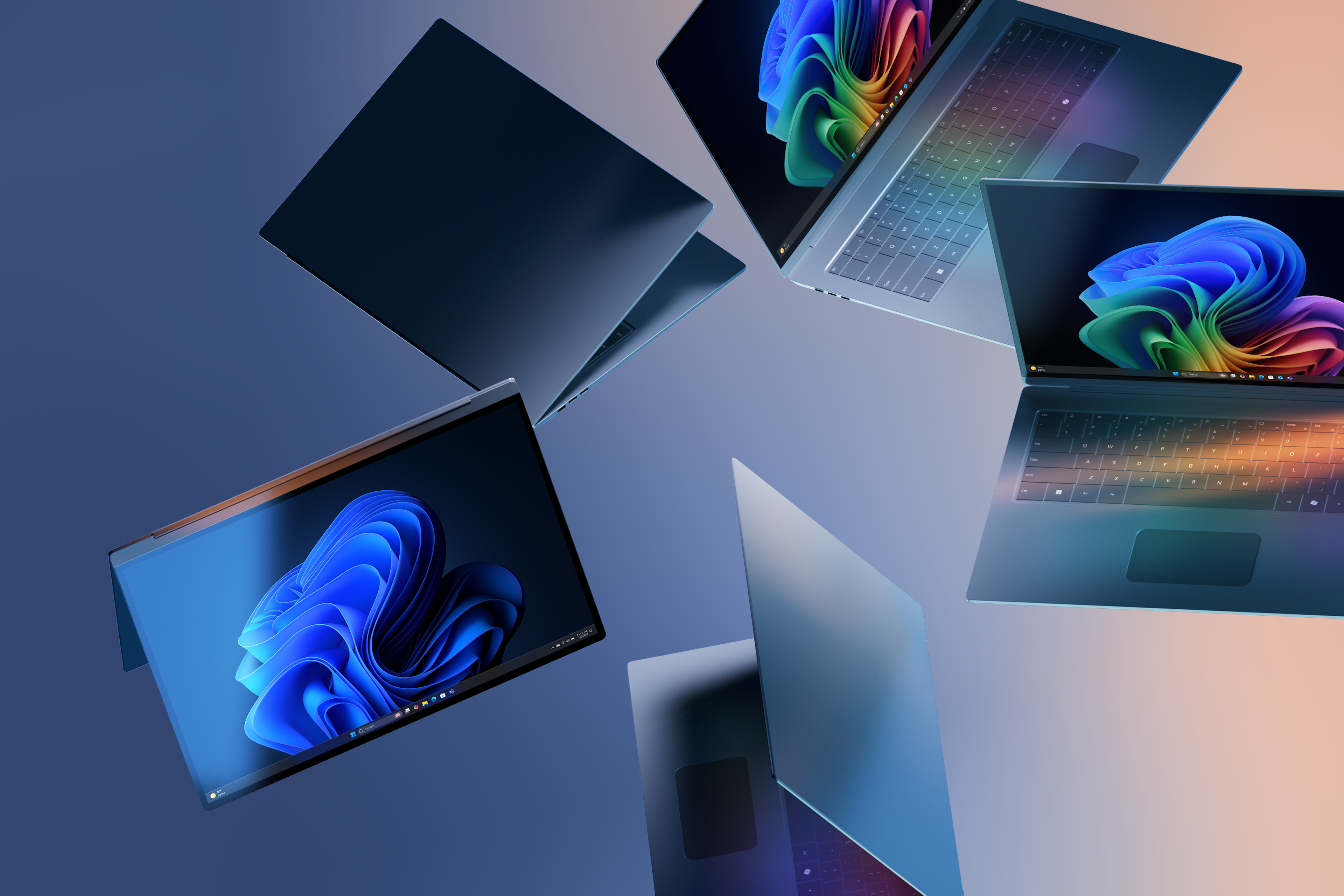 Five Windows 11 Pro devices dramatically arranged with two displaying the rainbow bloom image and one displaying the blue bloom image against a gradient blue and peach background