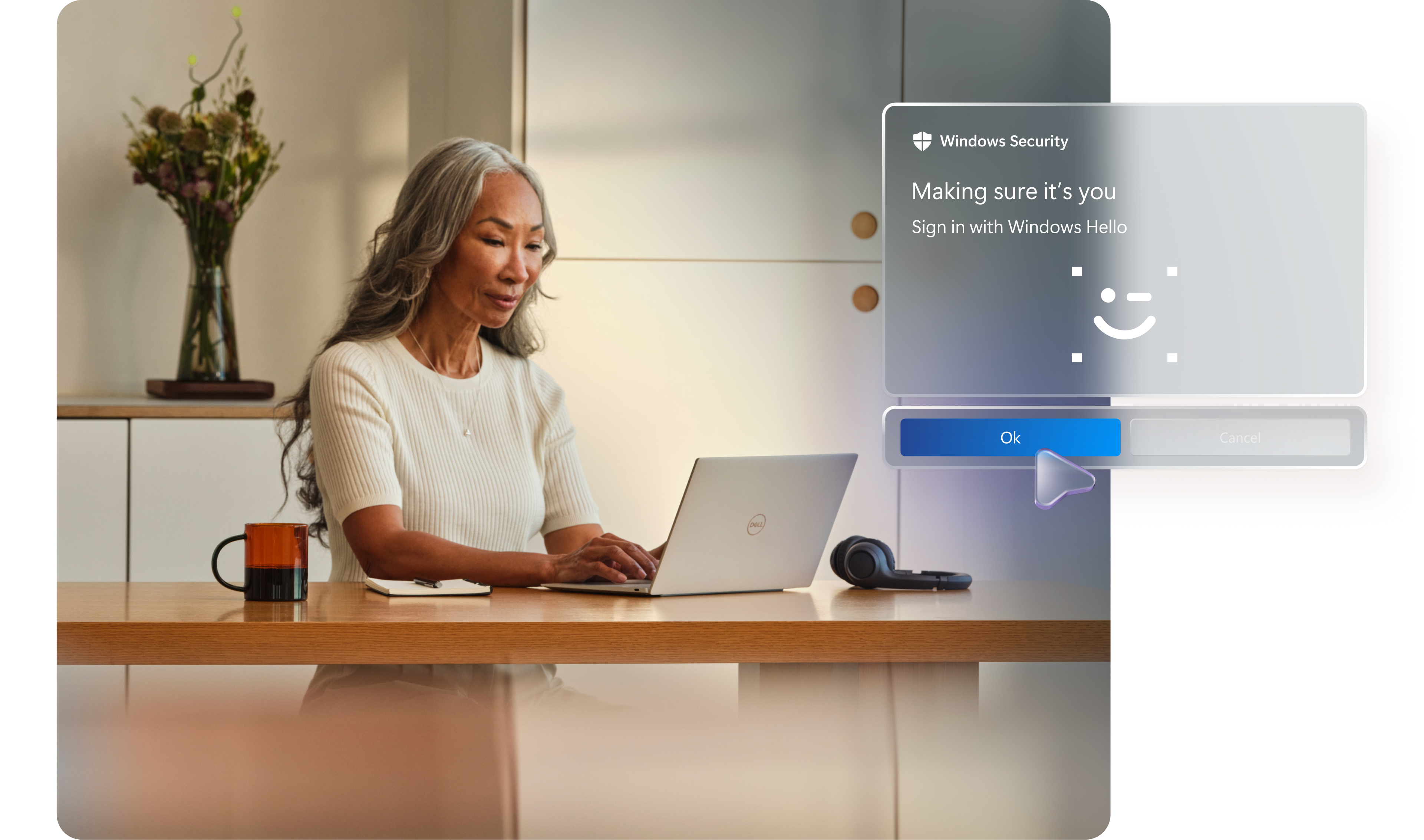 Person sitting at a work counter with an open laptop, wireless headphones sitting by the PC, a notepad, a coffee mug, and a vase of flowers in the background, with conceptual images showing secure sign in with Windows