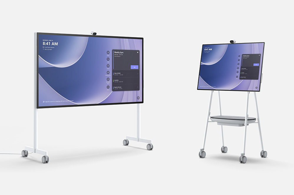 Una imagen que muestra una oficina con Surface Hub 3 de 50 pulgadas montado en la pared y Surface Hub 3 de 85 pulgadas en un soporte