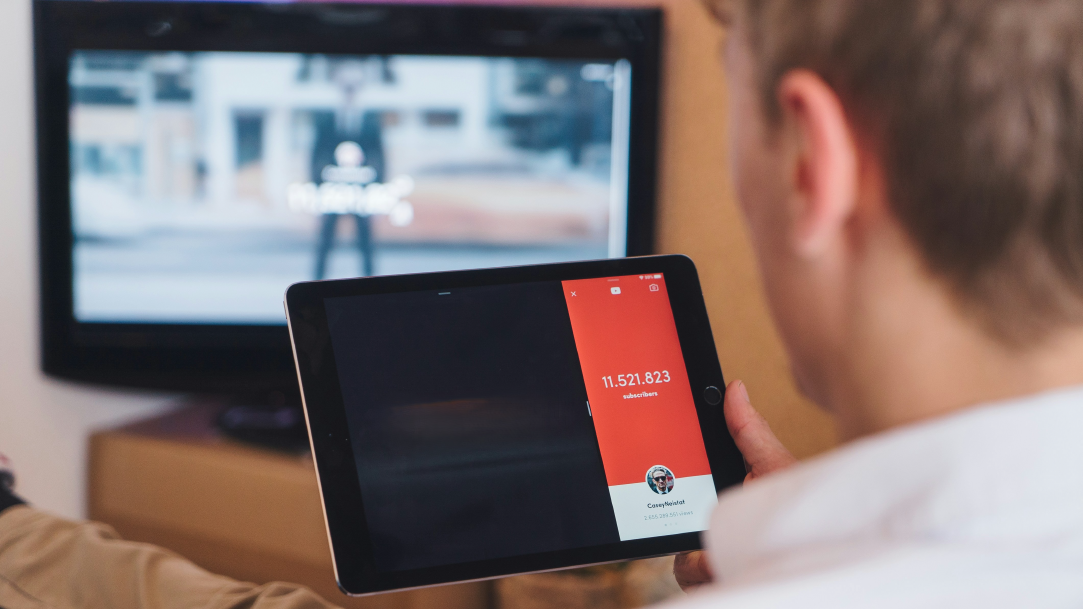 Image of a man using a tablet and watch TV