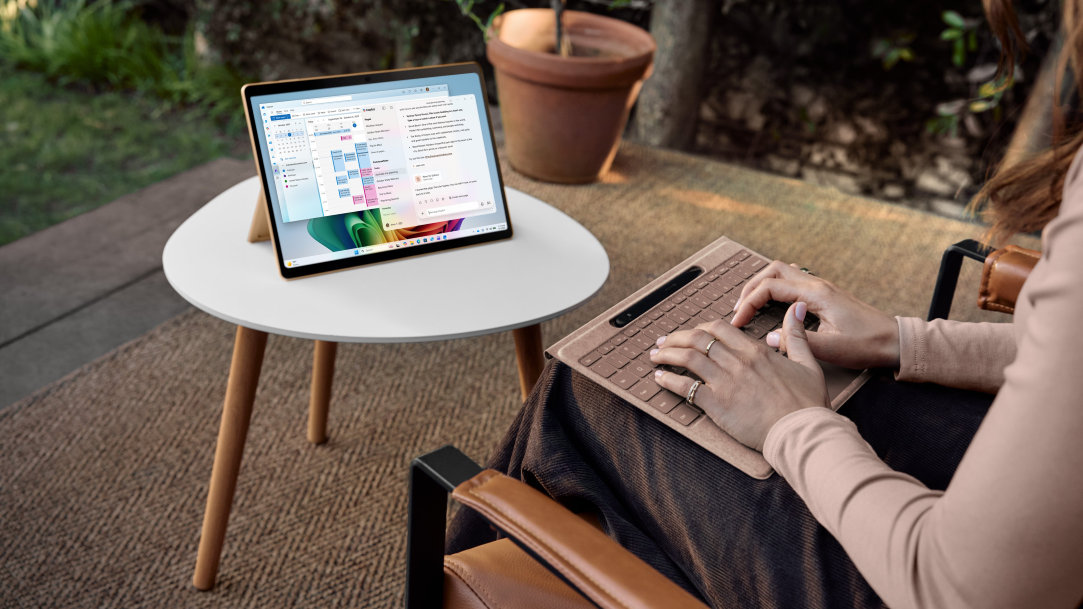 Image of a woman using Surface Pro with a detached keyboard on her lap