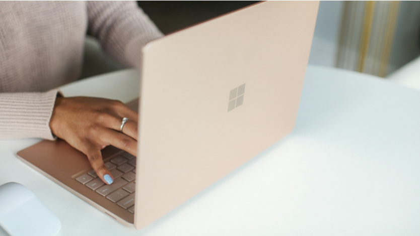 Image of a woman's hands typing on a Microsoft Surface device