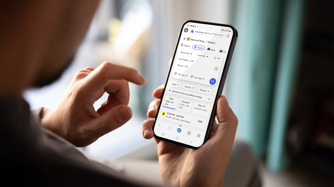 Man holding a mobile phone viewing the Copilot in Edge screen
