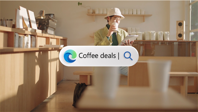 Man sitting in a coffee shop with an Edge Coffee deals search bar