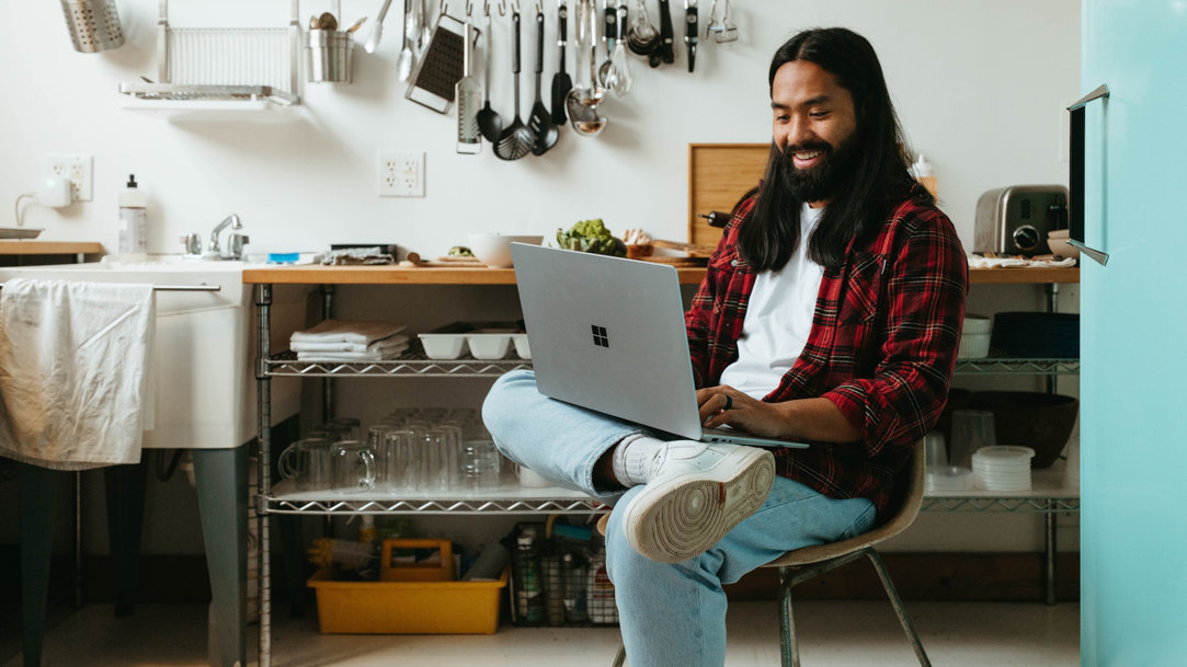 Man using Surface device in kitchen