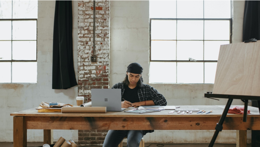 Man working in studio with a Surface laptop