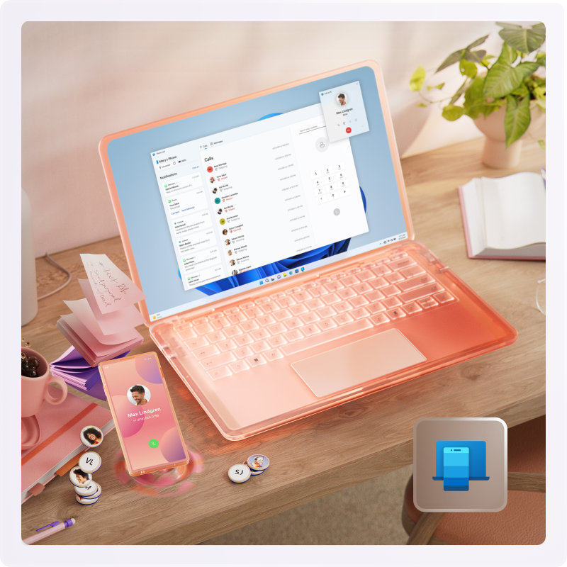 A pink book, mug, sticky notes, cell phone, and open laptop sitting on a desk.