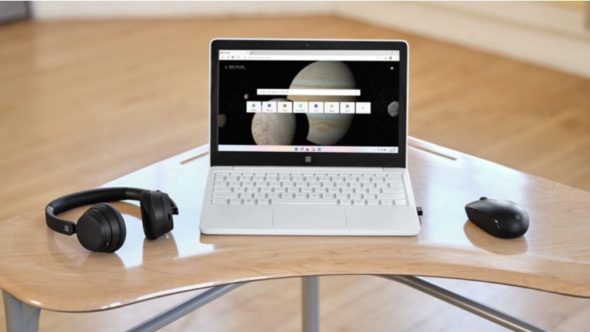 Surface laptop with wireless headphones and mouse on a desk