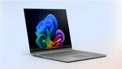 Laptop open with rainbow coloured bloom on desktop