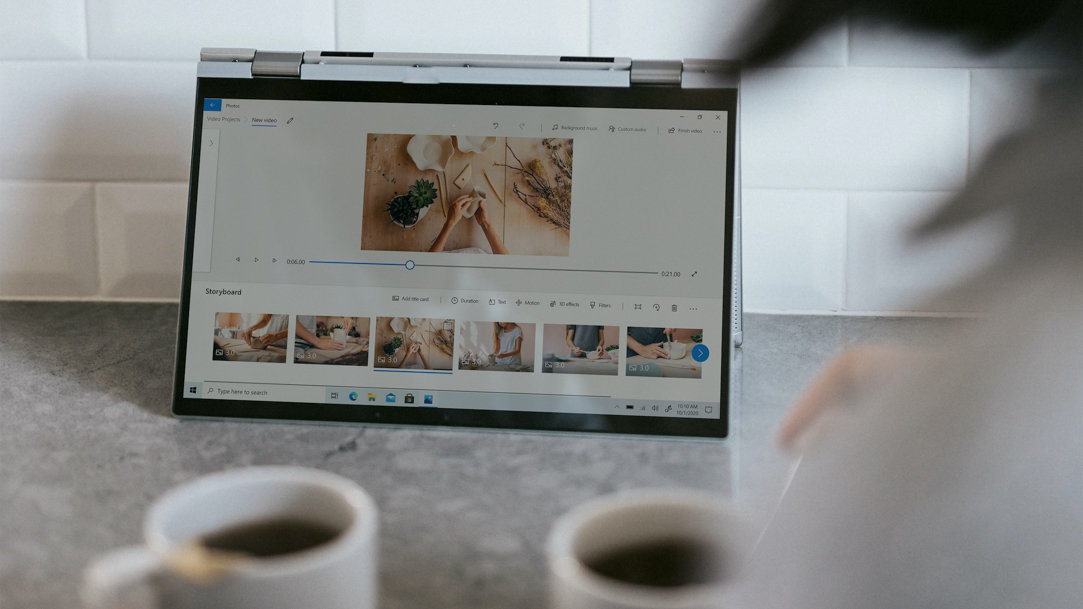 People drinking coffee and viewing photos on a Windows laptop