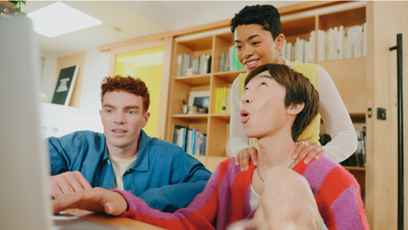 People laughing while looking at a Surface laptop