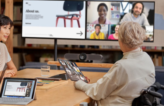 People sitting at a table joining a conference call