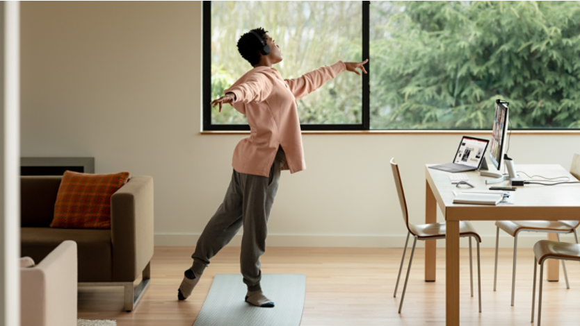 Person doing yoga poses in front of a Surface device