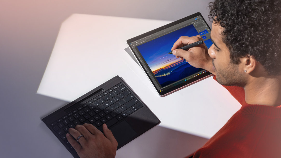 Person drawing on a Surface Pro 11ᵗʰ edition and using the Pro Flex Keyboard