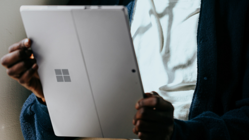 Person holding a Surface 2 -in -1 as they enjoy content