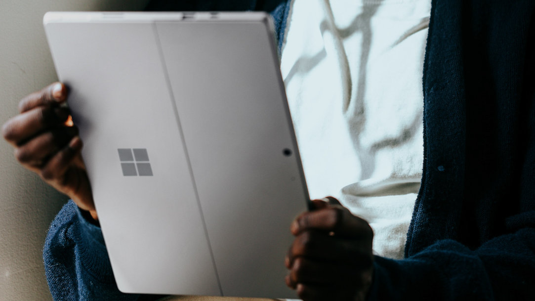 Person holding a Surface 2-in-1 as they enjoy content