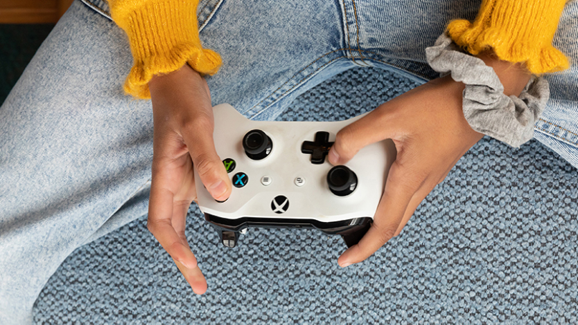 Person holding gaming controller