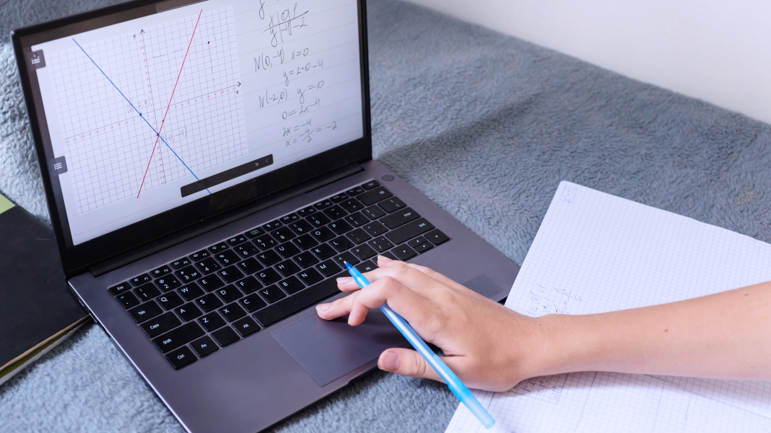 Person holding tablet with math diagrams on screen