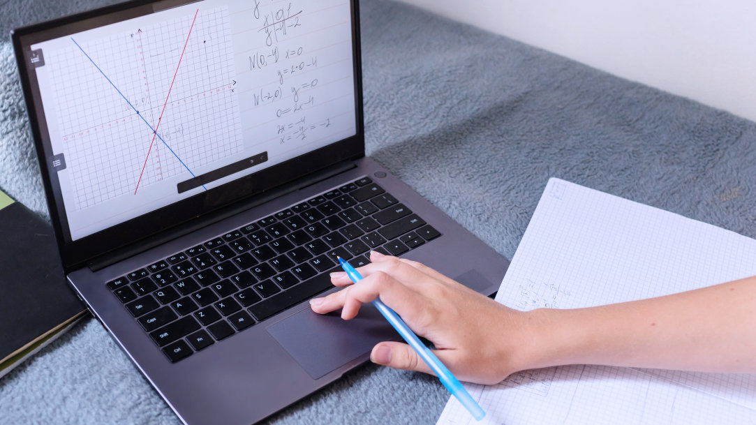 Person holding tablet with math diagrams on screen
