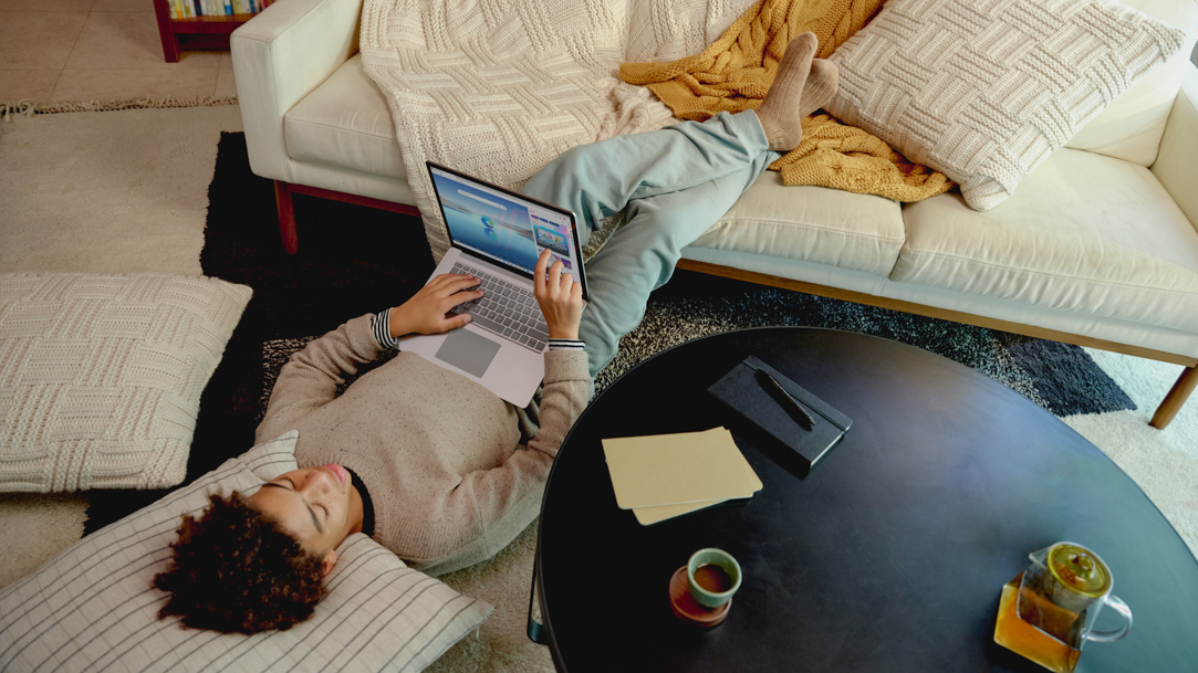 Person laying down while holding a laptop that has Microsoft Edge open