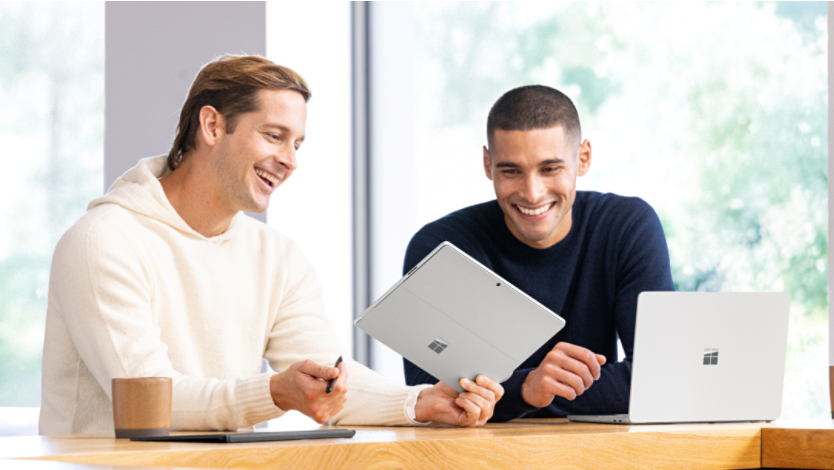 Person smiling while viewing their Surface device