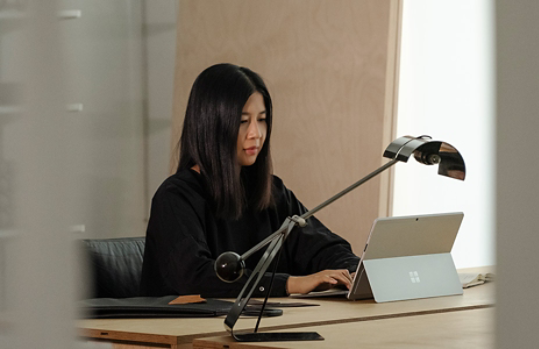 A person using Surface Pro X as a laptop in their office.