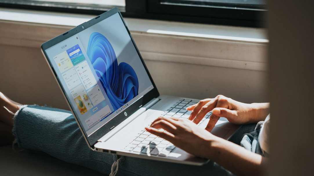 Person using a laptop with a Windows screen