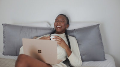 Person watching a movie on their laptop at home with bowls of popcorn