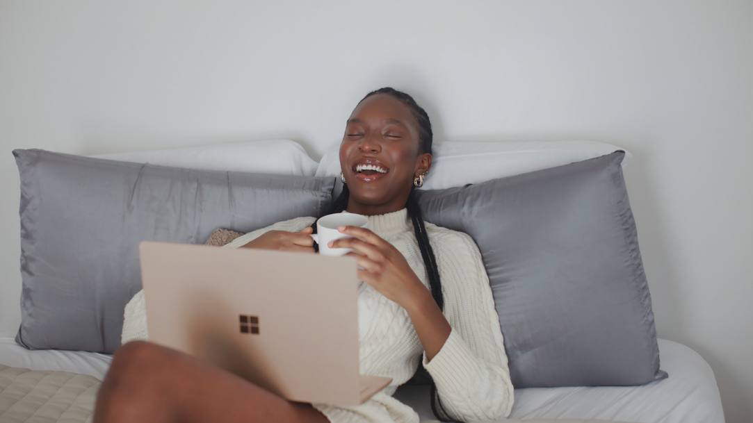 Person watching a movie on their laptop at home with bowls of popcorn