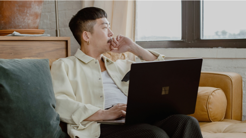Person with Surface laptop sitting on couch