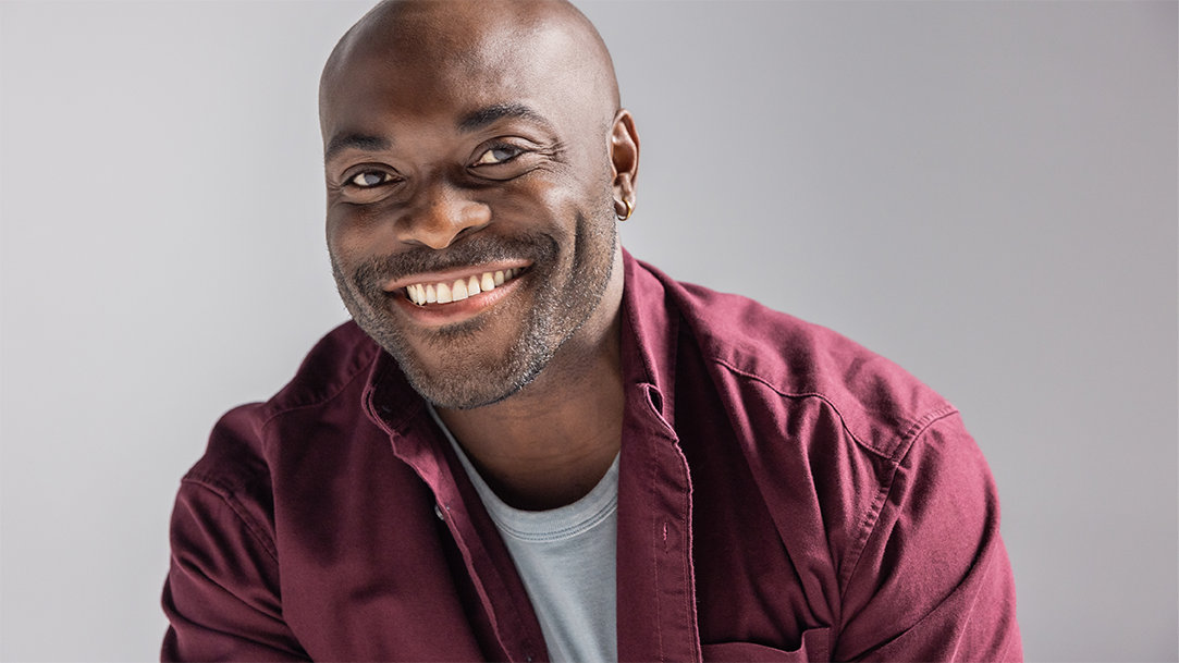 Portrait of a smiling man who has used Microsoft Copilot to book tickets to dinner and a show