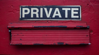 Private sign on a red door