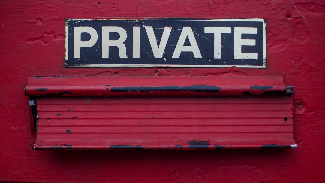 Private sign on a red door