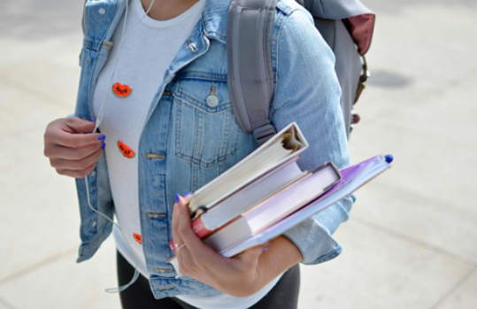 Student holding books on the way to class