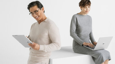 Man and woman working with Surface Laptop 6 in different device configurations of tablet and laptop