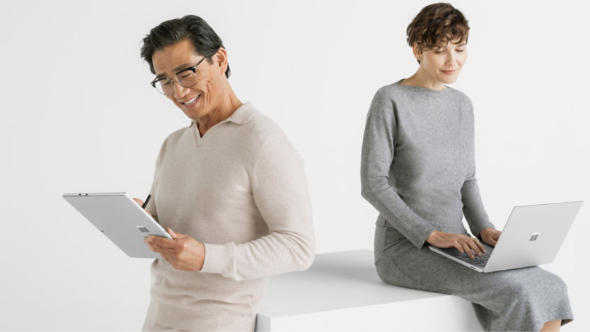 Man and woman working with Surface Pro 10 in different device configurations of tablet and laptop