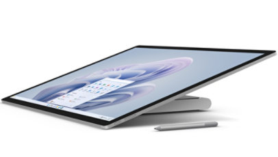 Surface Studio 2+ shown from the side, tilted back to almost flat with a Surface pen.