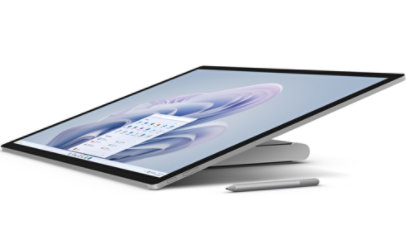 Surface Studio 2+ shown from the side, tilted back to almost flat with a Surface pen.