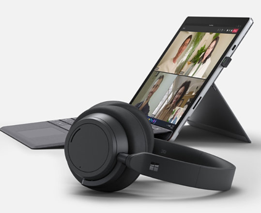 A render of a Surface device with Surface Headphones 2+ in the foreground